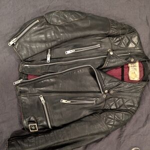 vintage black leather moto jacket with silver hardware